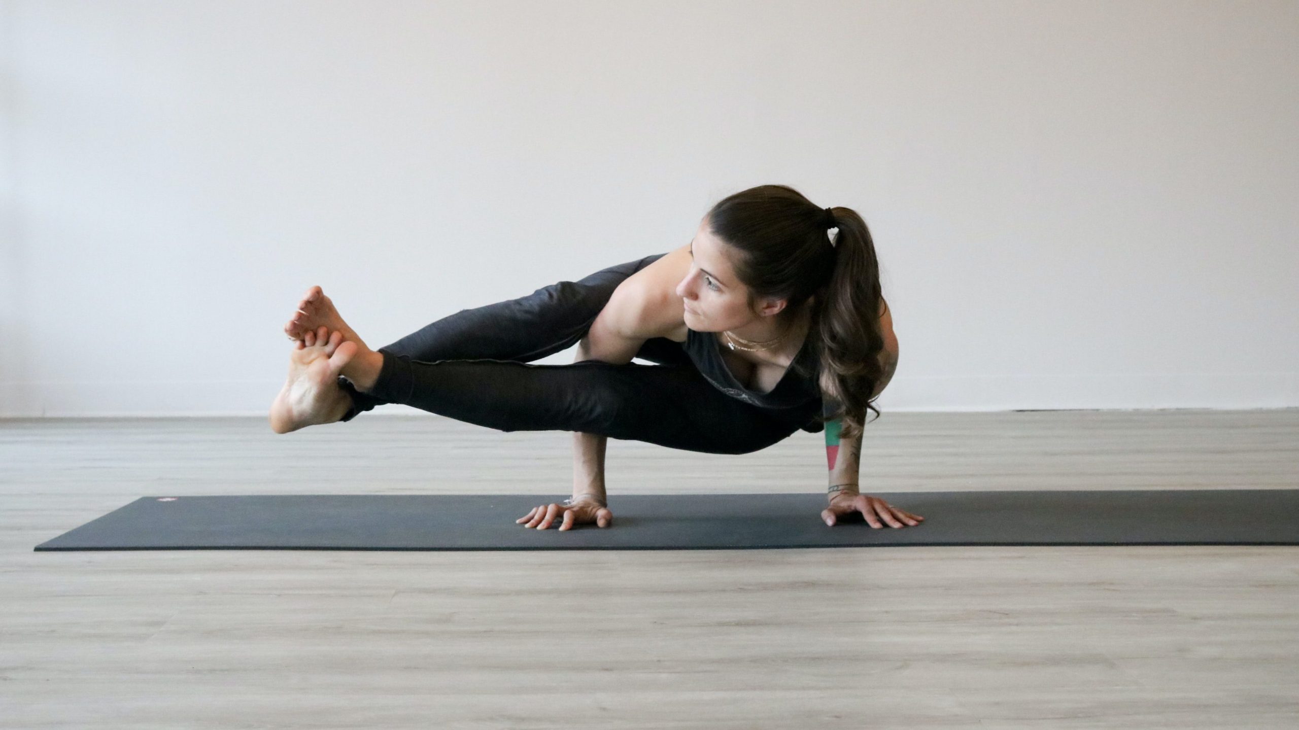 Woman performing a complicated yoga move