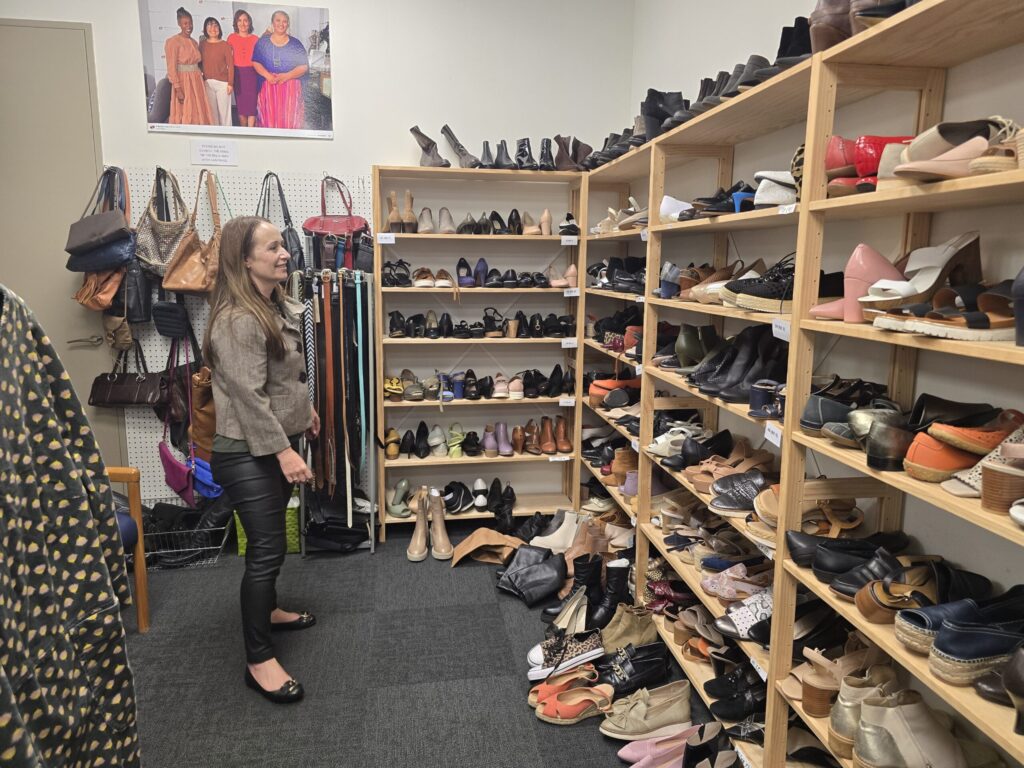 Emily Owens browses the shoe rack at the Khyber Pass Dress for Success clothing boutique