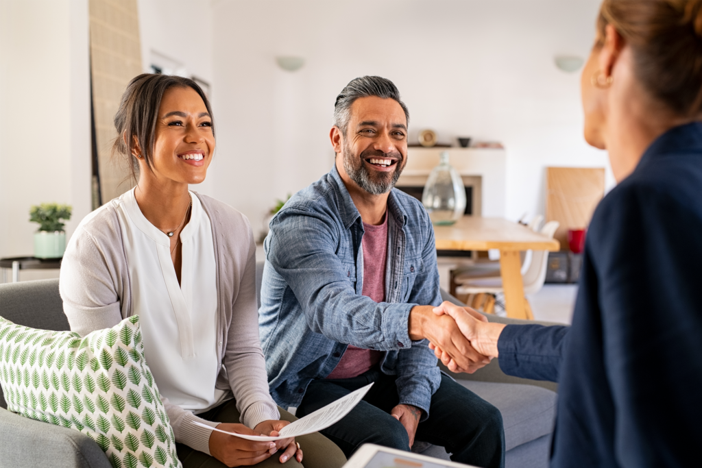 A smiling couple talking with a financial coach