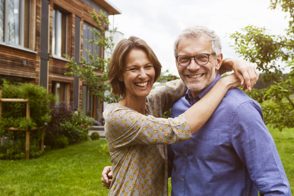 Happy future-ready older couple in their garden