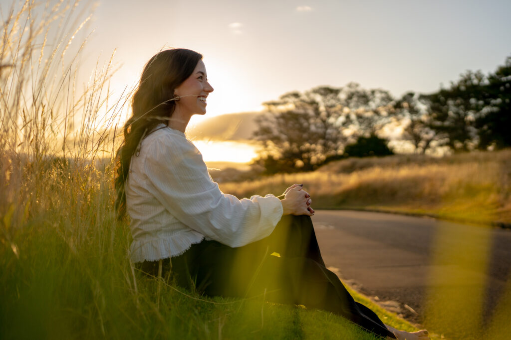 Confident woman looking out at sunset