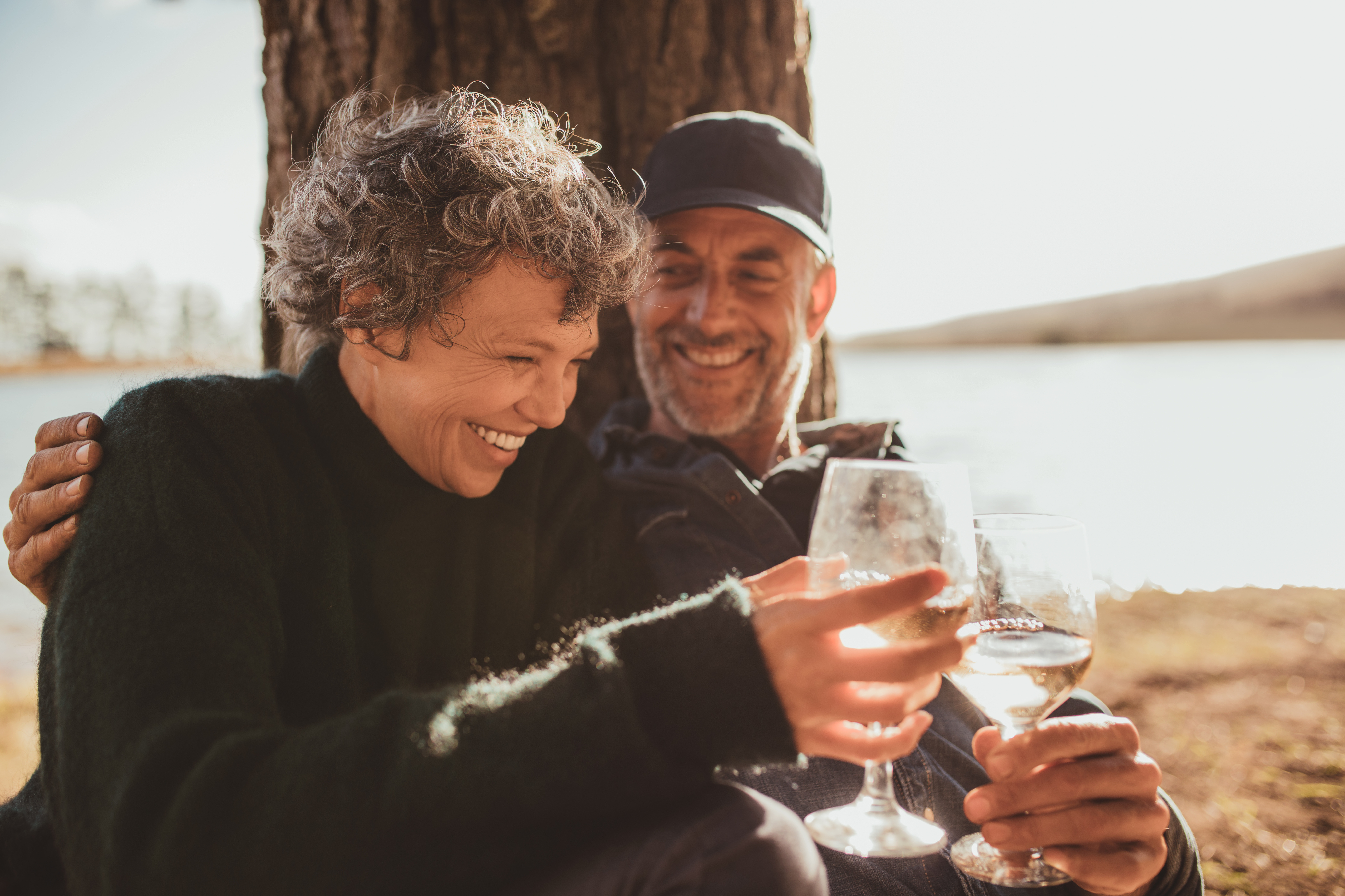Relaxed mature couple enjoying a glass of wine outside